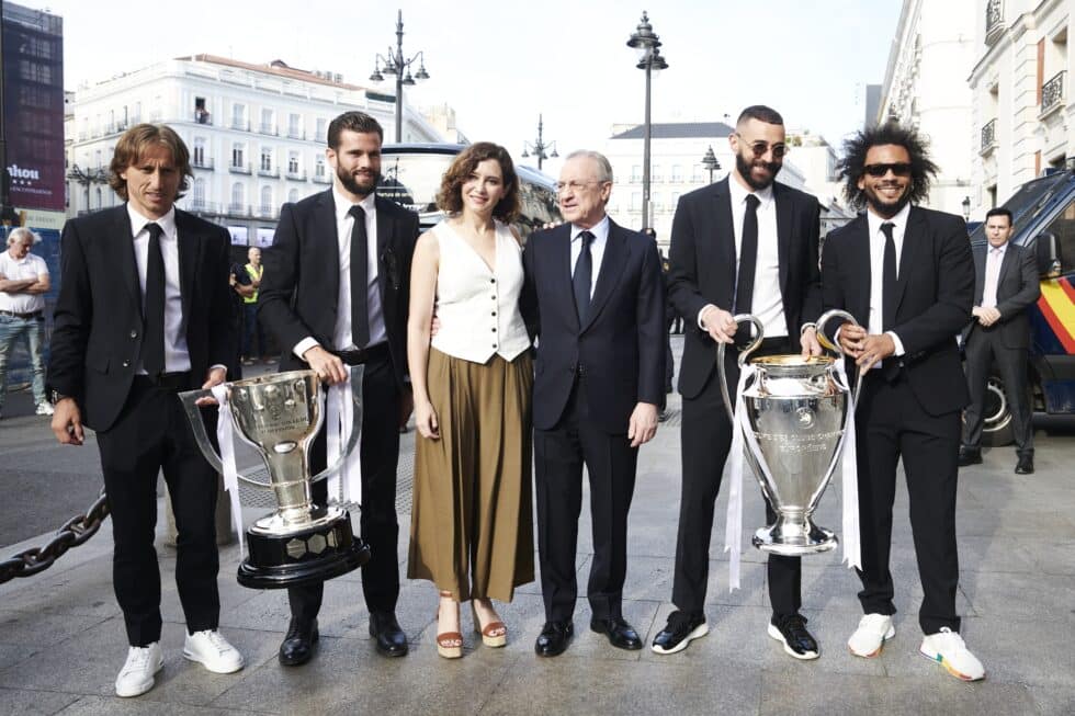 La presidenta de la Comunidad de Madrid, Isabel Díaz Ayuso (c), acompañada por el presidente del Real Madrid, Florentino Pérez, y los jugadores