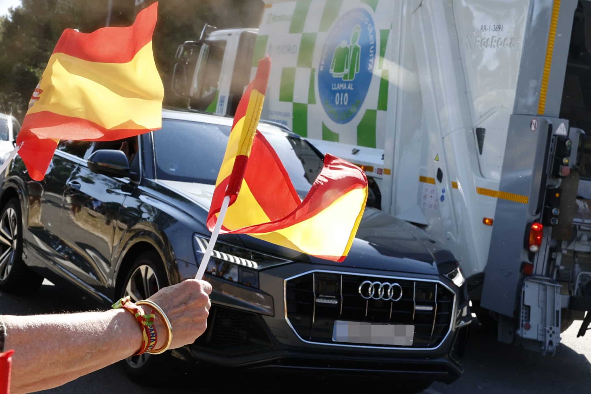 Seguidores del rey Juan Carlos ondean banderas de España durante su llegada este lunes al Palacio de la Zarzuela de Madrid.