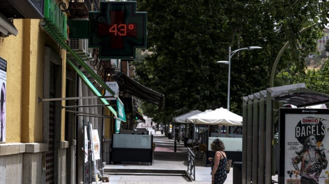 Una mujer pasa frente a una farmacia que marca 43 grados, este miércoles en Toledo.E