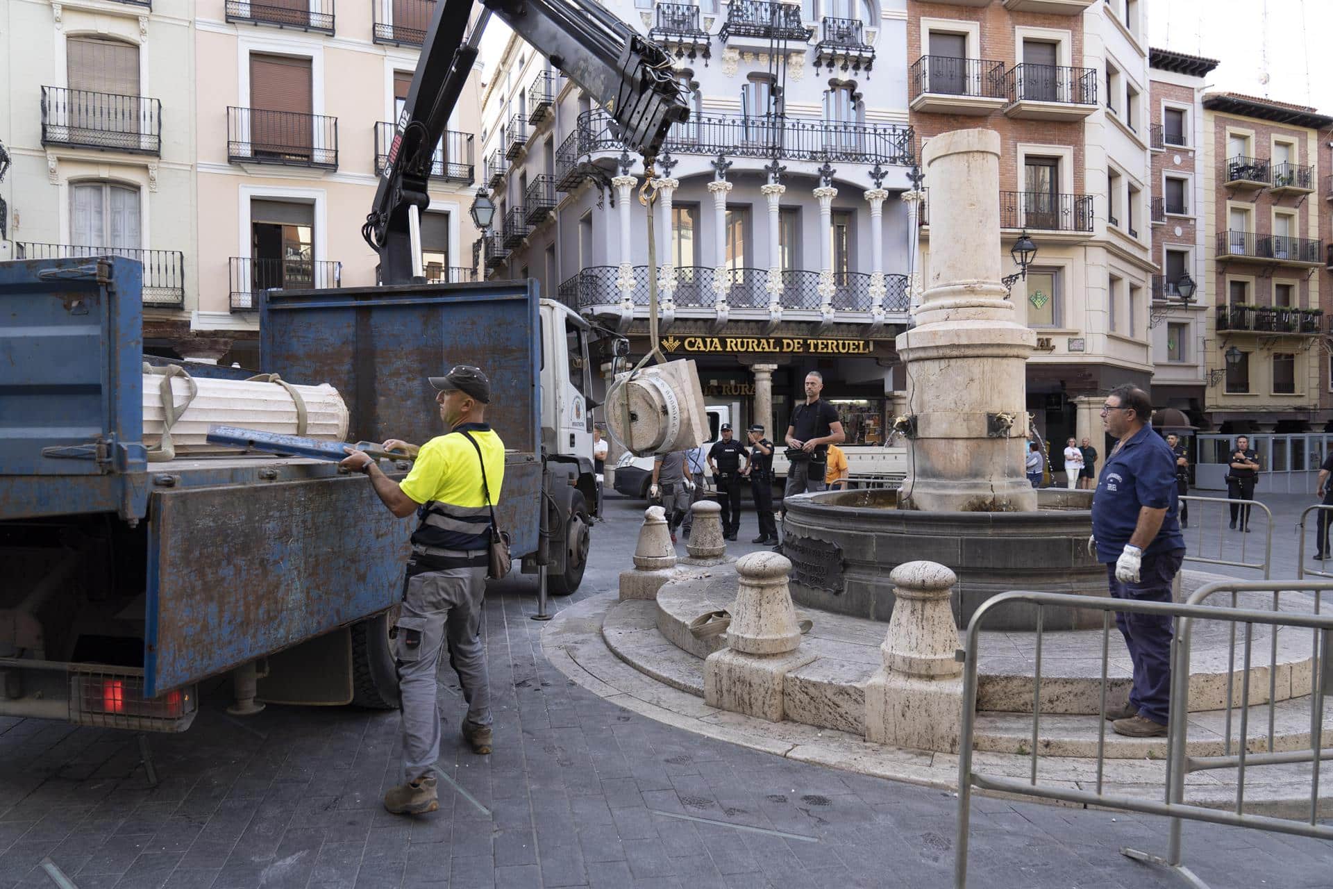 Operarios retiran los elementos dañados tras el derrumbe de la estatua del Torico de Teruel.