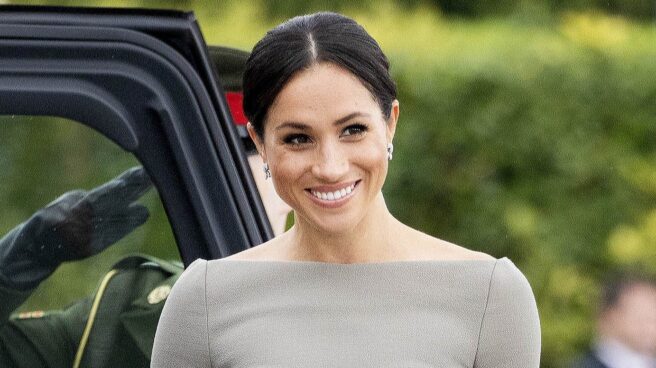 Meghan Markle sonriendo al salir de un coche en un acto oficial