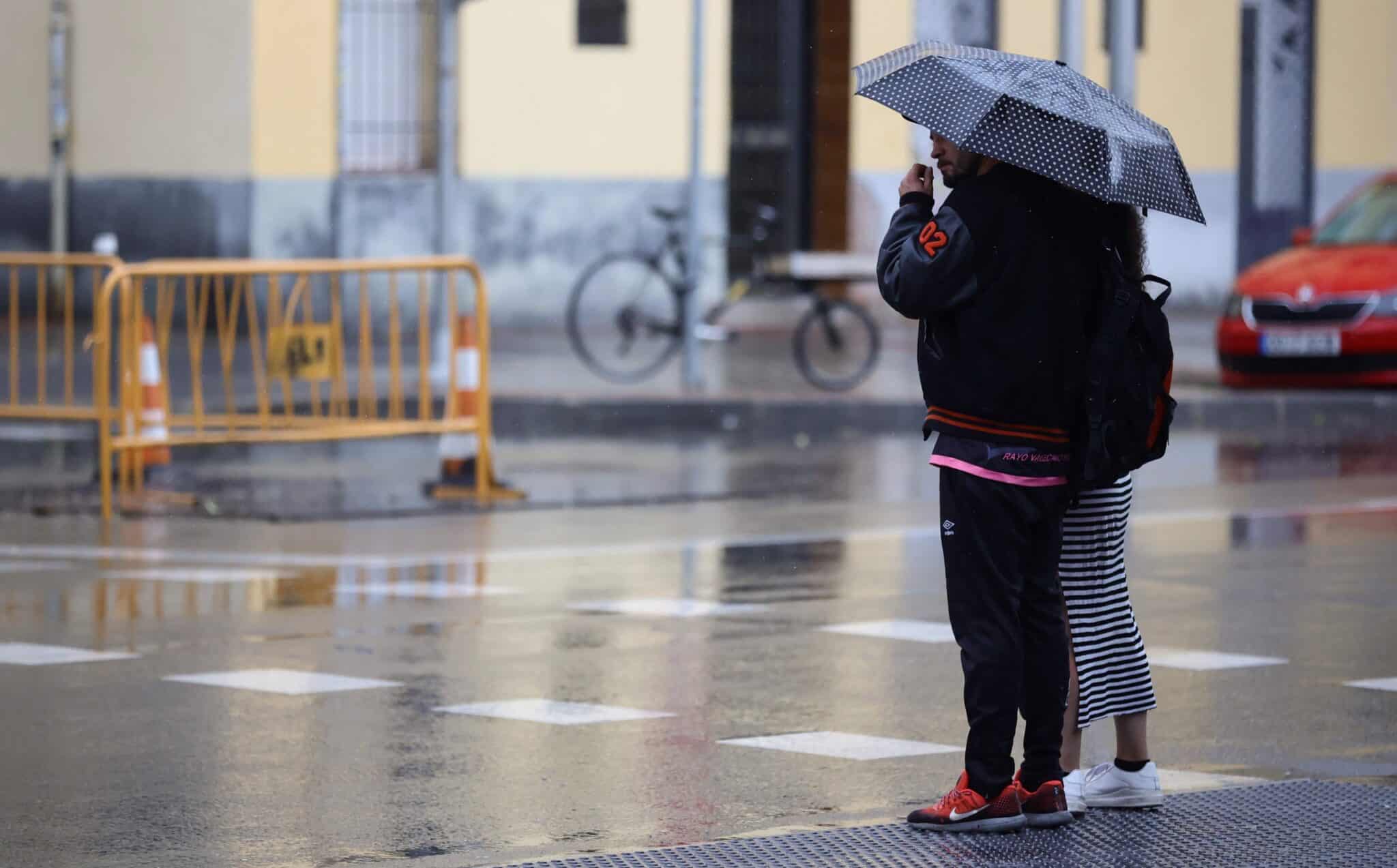 Varias personas caminan con paraguas en Madrid (España)