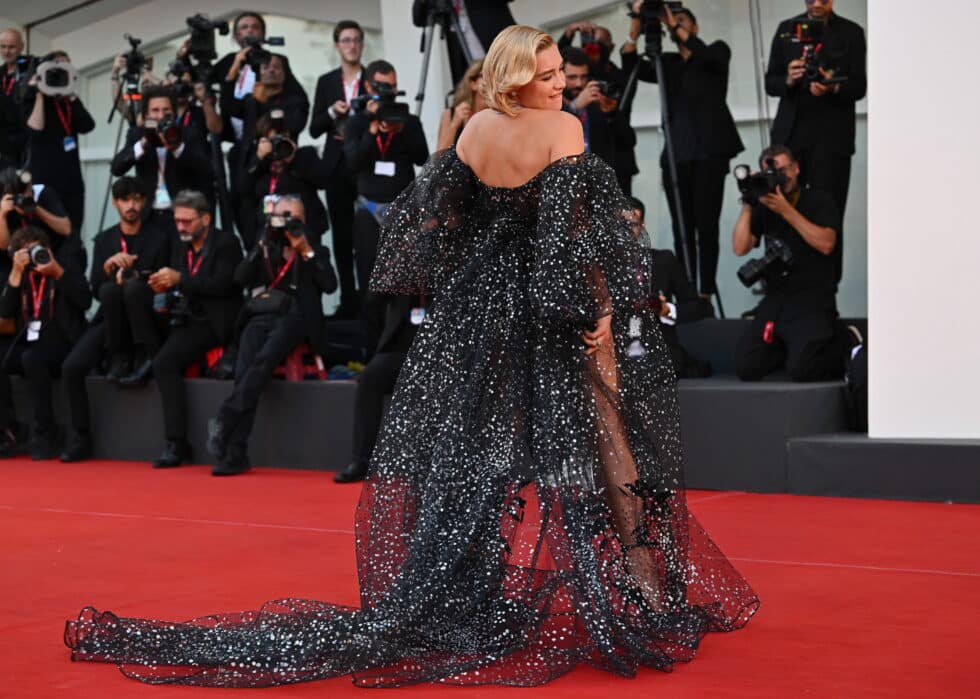 Florence Pugh, actriz principal de la película "Don't Worry Darling", con un vestido largo azul oscuro con transparencias en la alfombra roja del Festival de Venecia 2022