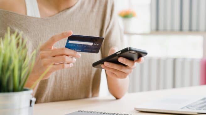 Mujer comprando con tarjeta de crédito en un comercio electrónico
