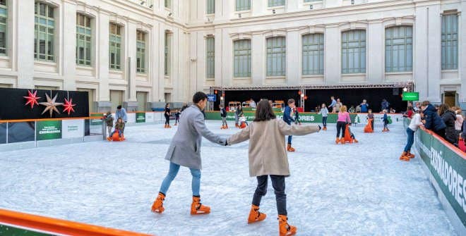 Personas patinando en la pista de hielo de Cibeles de Madrid