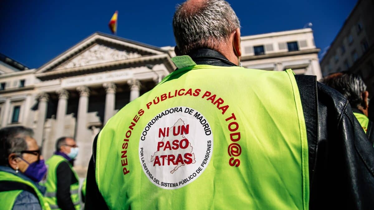 Un hombre participa en una concentración en favor de los pensionistas frente al Congreso de los Diputados.