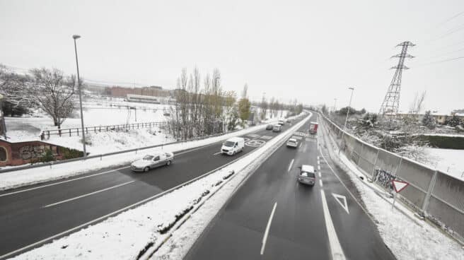 Nieve y frío en España, que tendrá temperaturas de -10º Varios coches circulan por una carretera con los laterales cubiertos de nieve