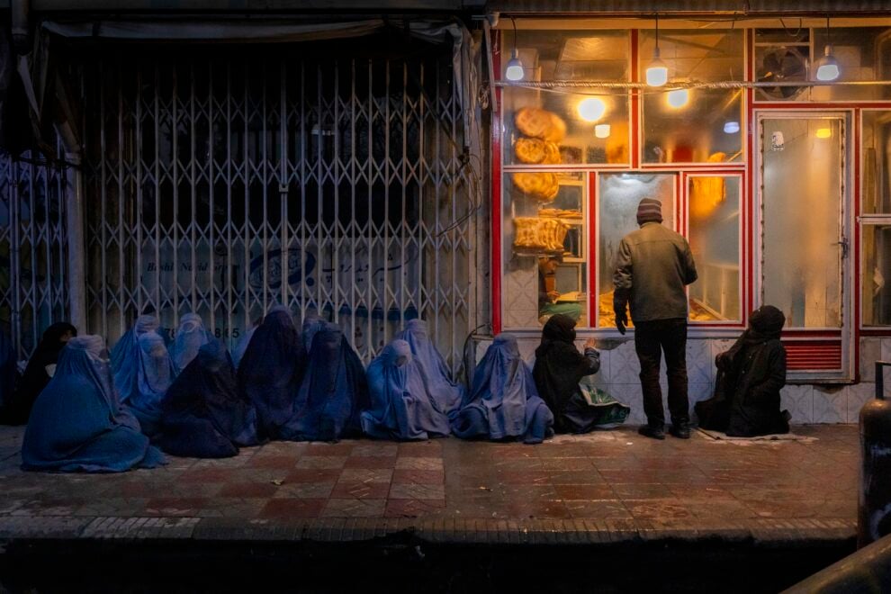 Mujeres piden comida en una panaderia en Kabul. 