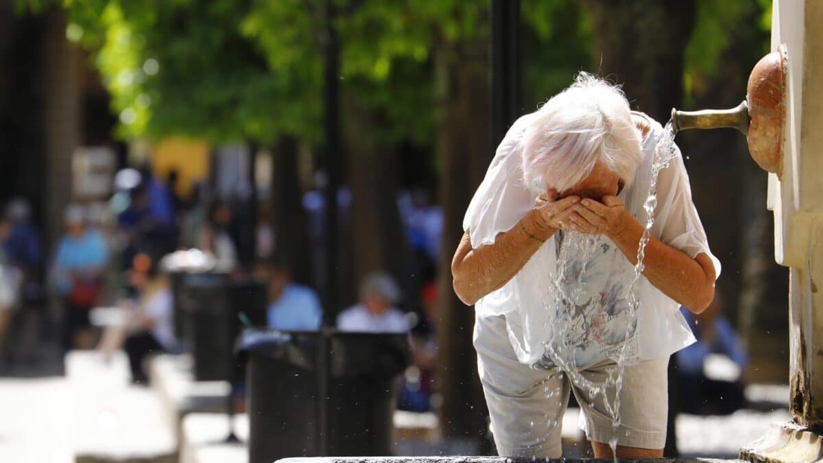 Una mujer se refresca en una fuente de Córdoba debido al calor sofocante.