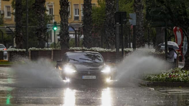 Las intensas lluvias provocan cortes en varias líneas de Metro, problemas en carreteras y desvíos de vuelos en Madrid Un coche levanta el agua de la lluvia caída en la tarde