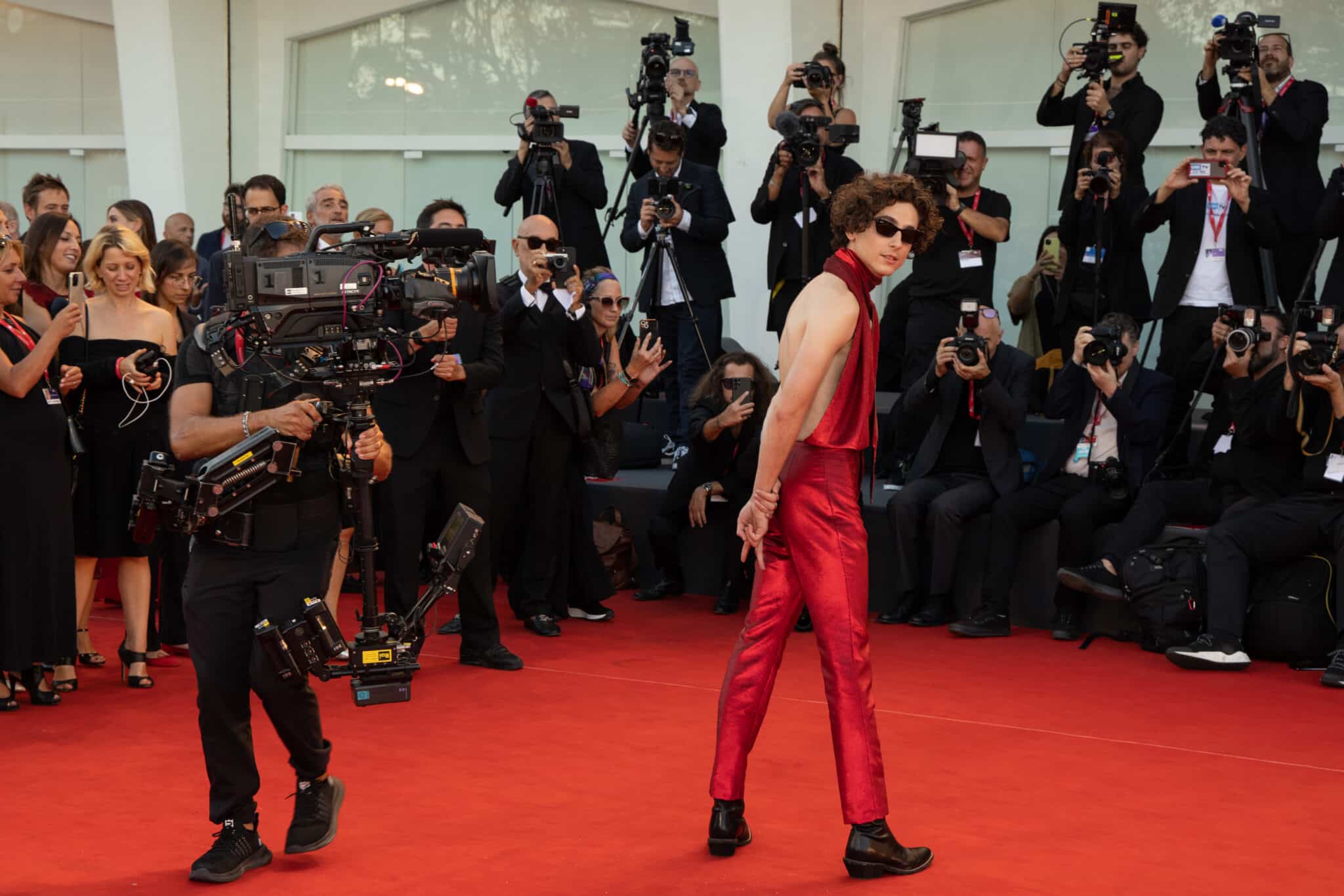 Timothée Chalamet made a splash at the Venice Film Festival by standing with his back in the air
