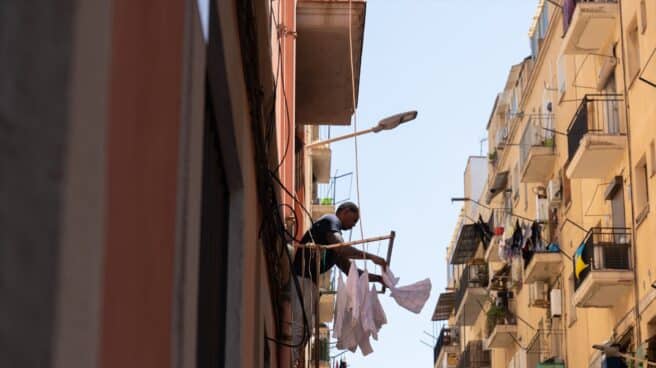 A man hangs clothes in Barcelona.