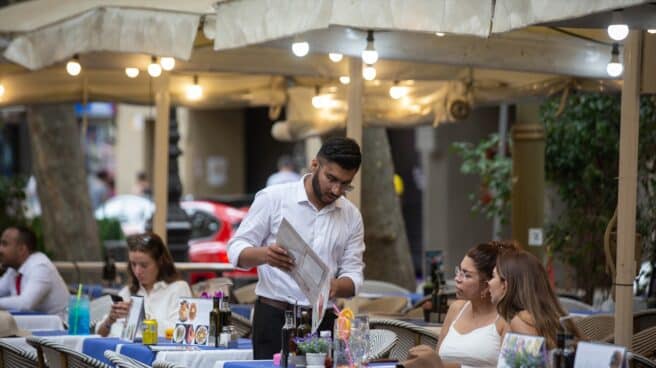 A waiter serves a table on the Ramblas in Barcelona.