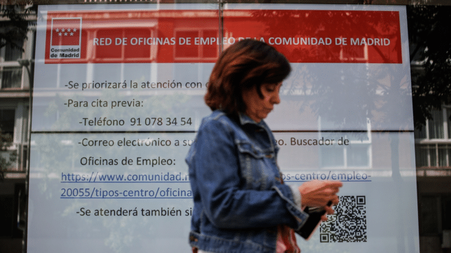 Una mujer frente a la oficina del SEPE que va al banco para preguntar cuándo se cobra el paro en junio 2023