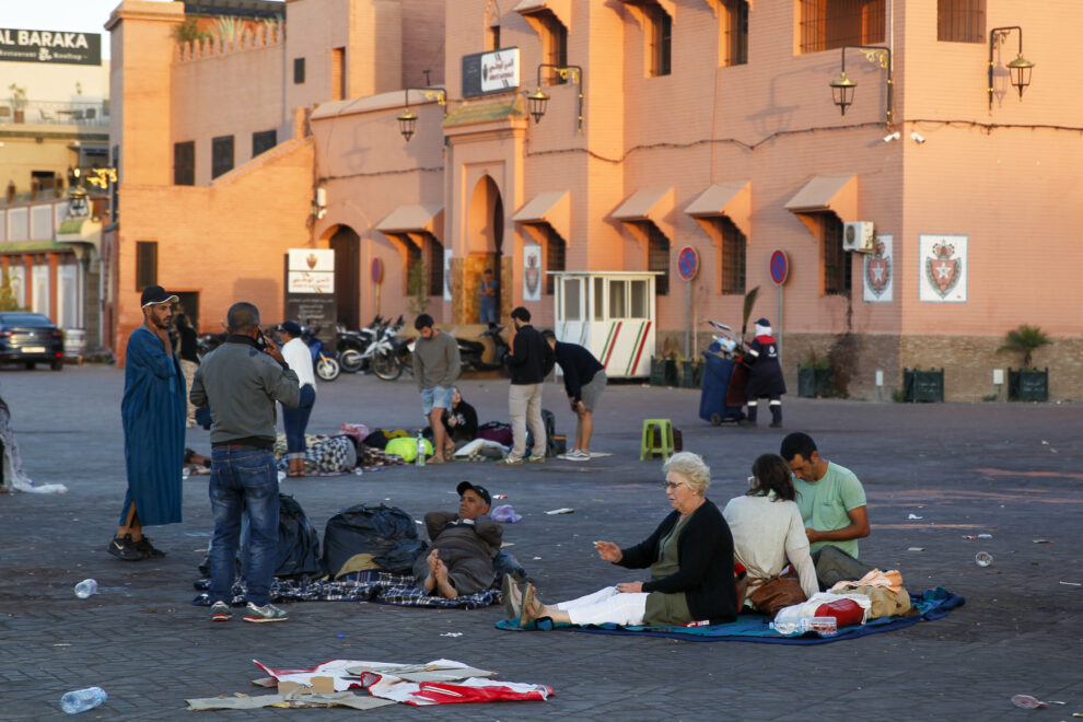 Varias personas descansan en medio de una calle de Marrakech a primera hora de este sábado.