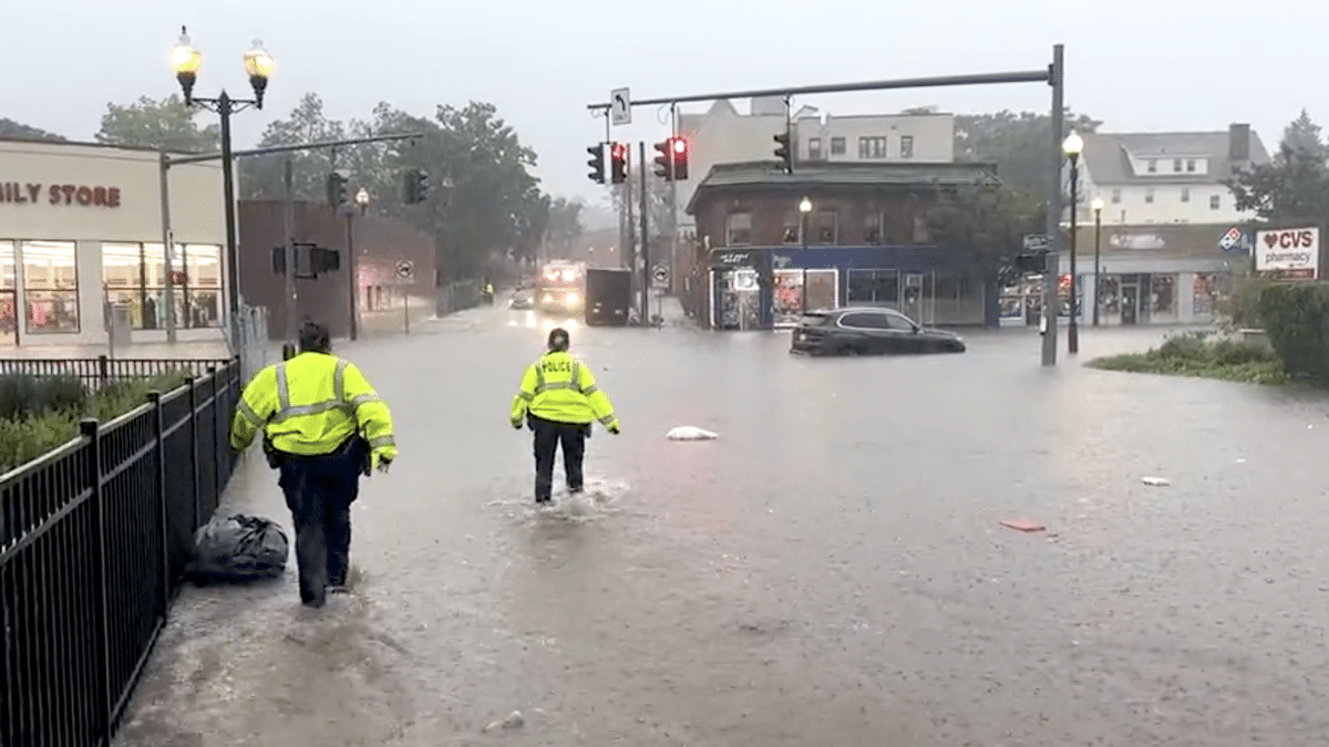 Dos policías de Nueva York cruzan una calle inundada por la tormenta Ophelia
