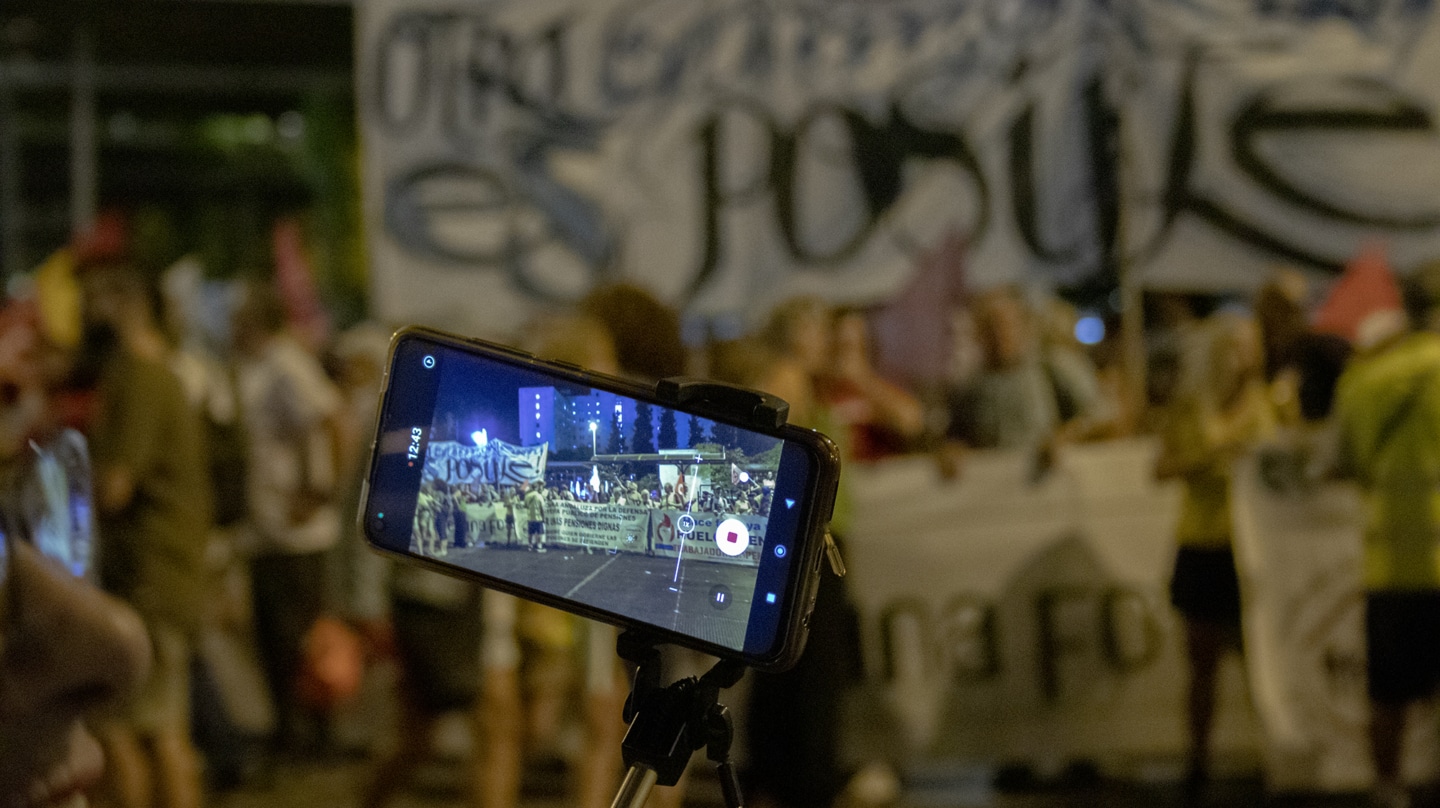 Participante con cámara en la manifestación contra la cumbre en Granada.