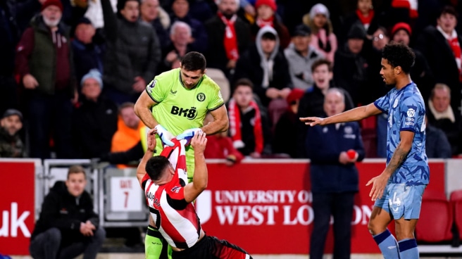 Emiliano Martinez lifts Neal Maupay's shirt during the Brentford-Aston Villa match