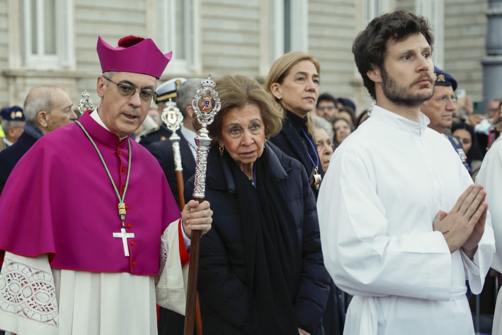 La reina Sofía y el arzobispo castrense Juan Antonio Aznárez (i) en la salida de la procesión del Santísimo Cristo de los Alabarderos, este Viernes Santo en el Palacio Real de Madrid.