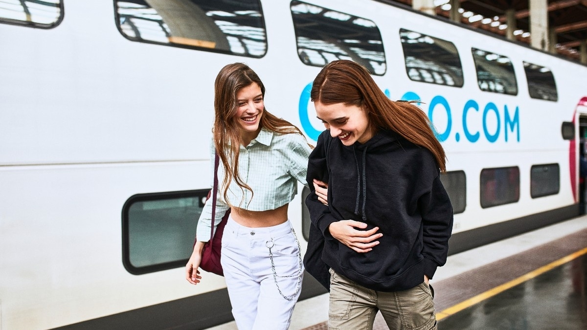 Jóvenes paseando al lado de un tren OUIGO