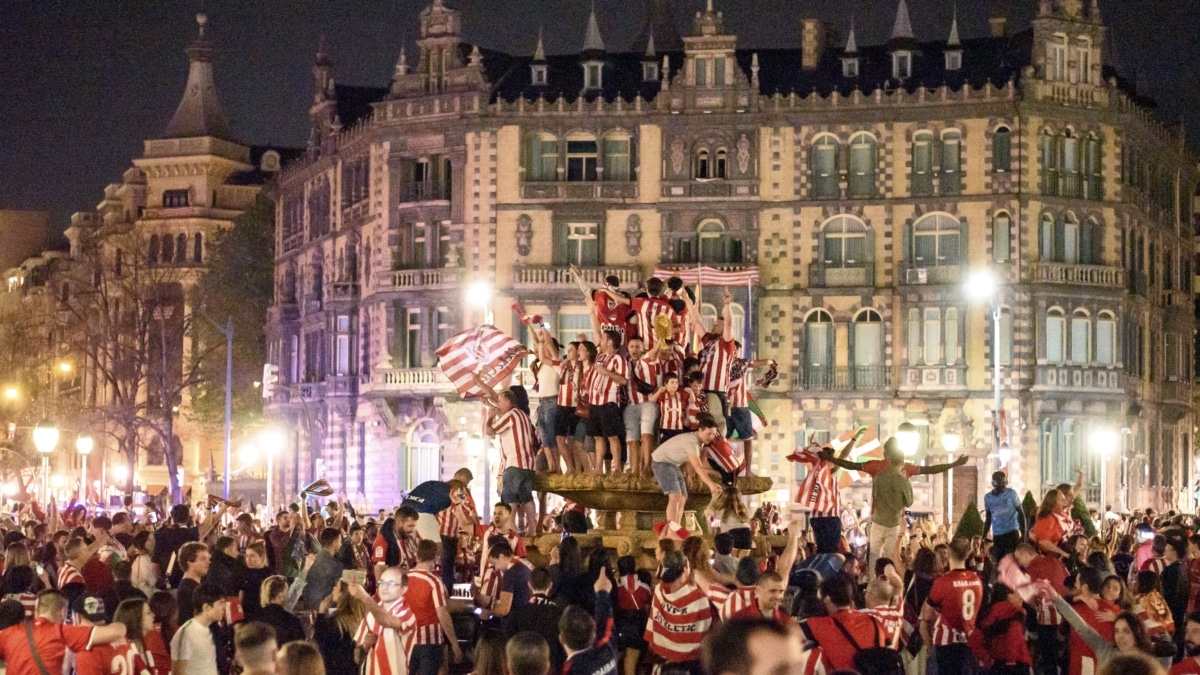 Aficionados del Athletic Club celebran en la fuente de la plaza Moyua de Bilbao en la madrugada de este domingo