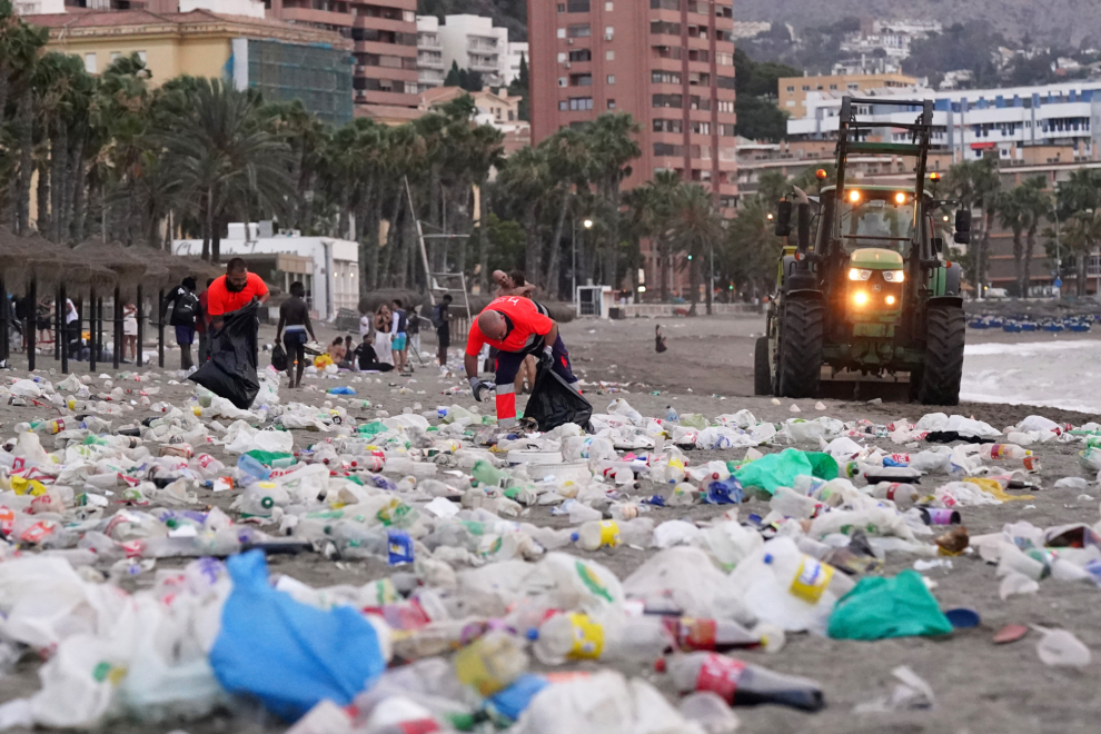 Miembros del servicio de limpieza municipal de Málaga recogen restos de basura