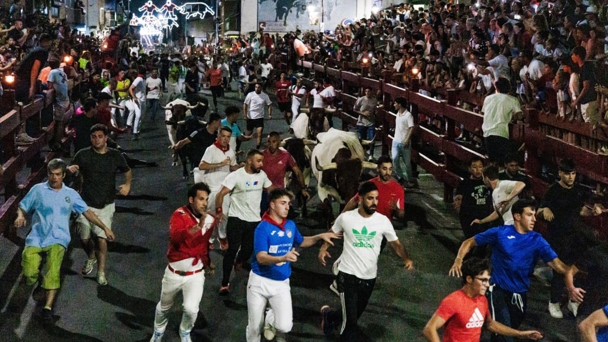 Varios corredores durante el encierro nocturno en las fiestas de San Sebastián de los Reyes.