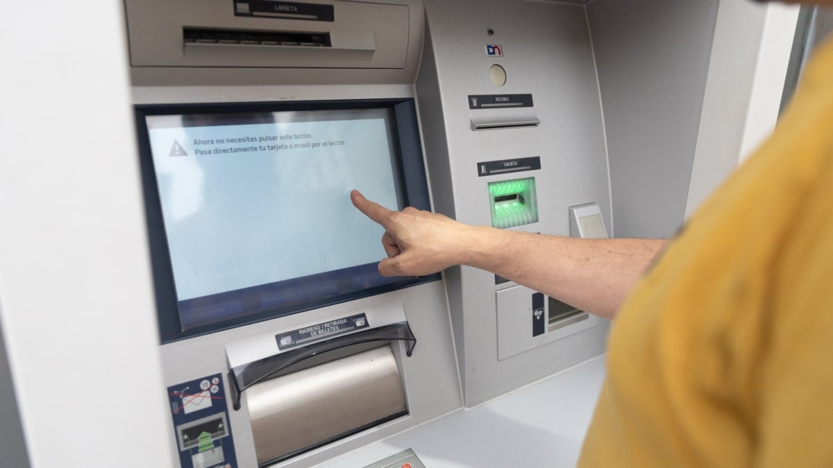 Un hombre utiliza un cajero automático.