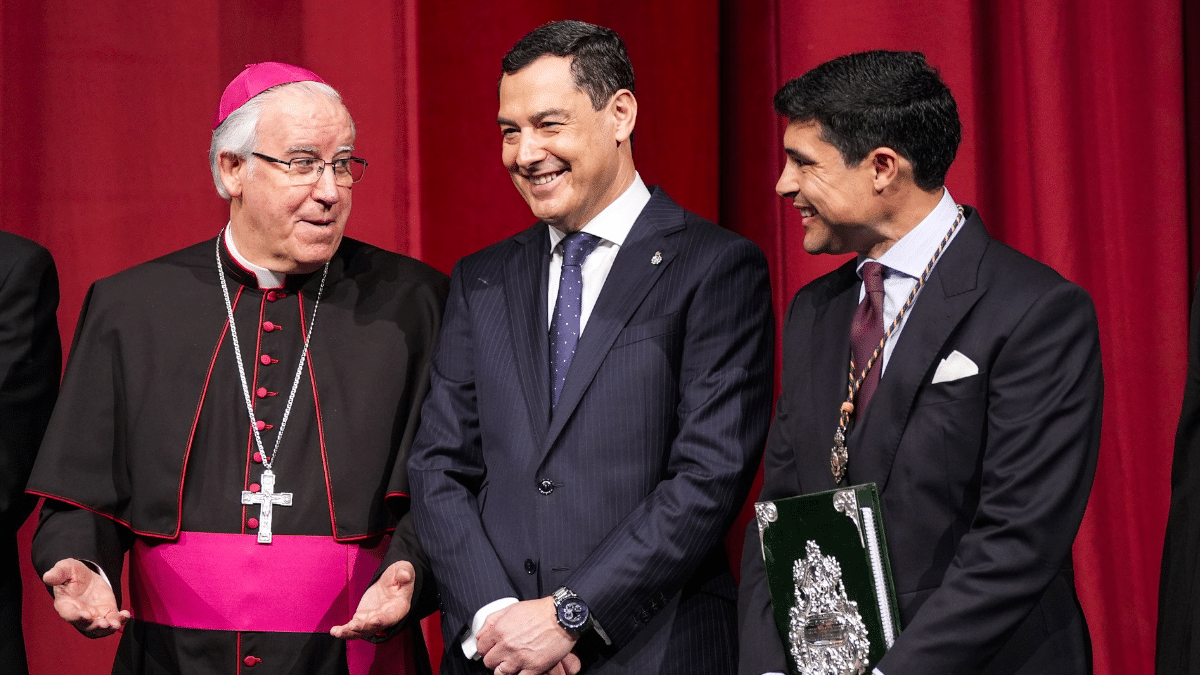 El presidente de la Junta de Andalucía, Juanma Moreno, este domingo entre monseñor Saiz Meneses y el periodista José Antonio Rodríguez Benitez durante el pregón de la Semana Santa de Sevilla.