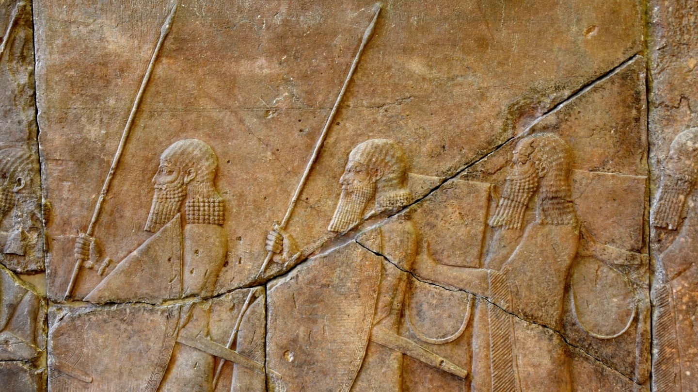 Alabaster bas-relief, a procession of 2 Assyrian soldiers and 2 musicians carrying rectangular drums with drag ropes. Reign of Sennacherib, 704-681 BCE. From the sidewalls of a ramp leading up (from the Royal Palace) to the Temple of Ishtar, Nineveh, Iraq. Pergamon Museum, Berlin, Germany