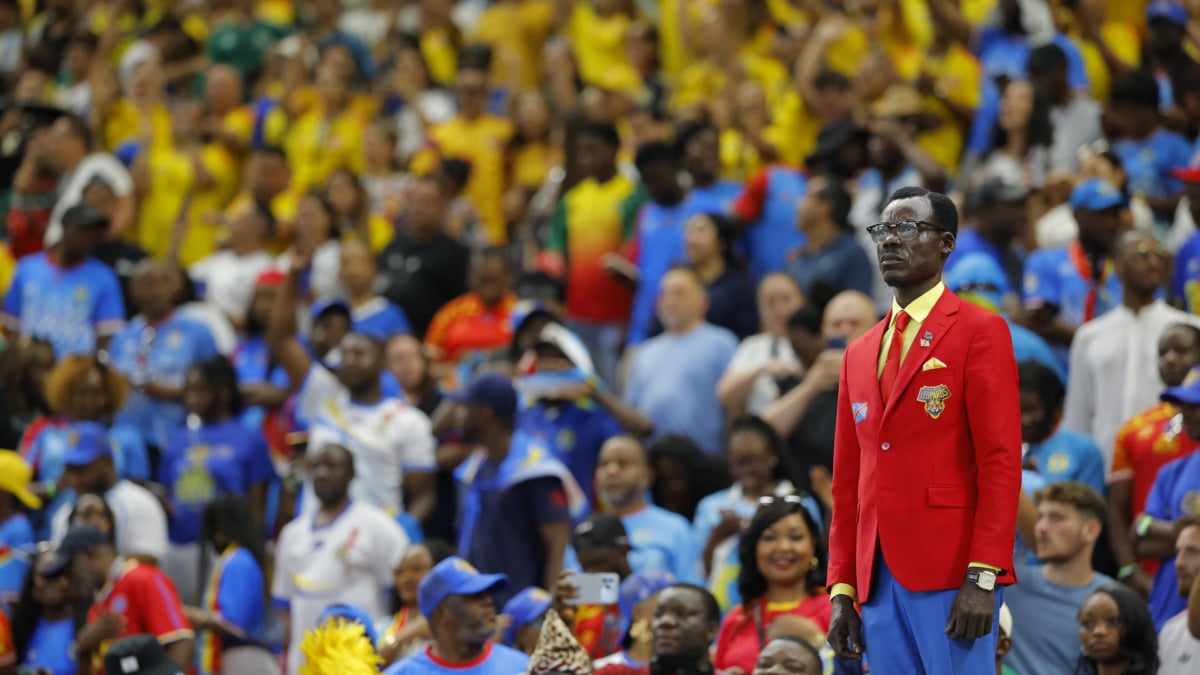 El aficionado de Congo conocido como Lumumba Vea posa como la estatua del líder de la independencia del país africano