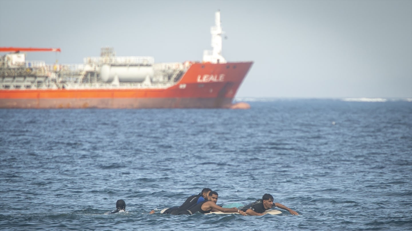 Varios migrantes a bordo de una colchoneta, en la playa del Trampolín, a 23 de septiembre de 2026, en Ceuta